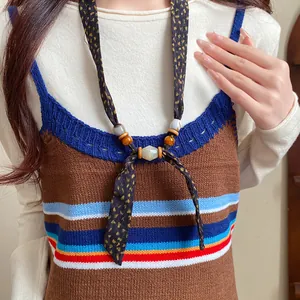 Close-up view of a Bohemian fabric necklace with wood beads and chiffon patterns