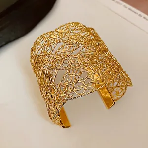 Minimalist gold woven wire open cuff bracelet featuring a sophisticated metal mesh design