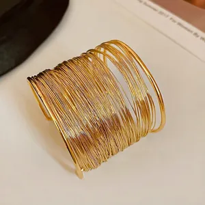 Exaggerated wide multi-strand gold wire cuff bracelet with minimalist open design