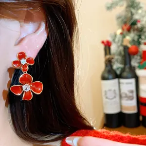 Detailed view of elegant red flower earrings with sparkling zircon stones