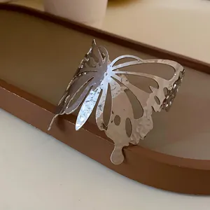 Close-up of a silver butterfly open cuff bracelet with hammered metal texture
