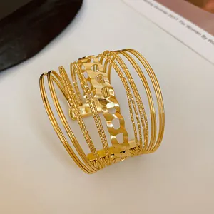 Close-up of a minimalist multi-strand gold cuff bracelet with chunky chain link detail