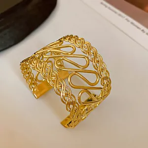 Detail view showing the intricate gold openwork pattern of this vintage cuff bracelet.