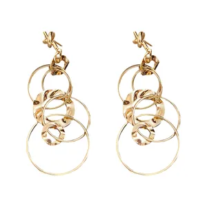 Elegant gold knotted earrings with hammered interlocking rings on white background