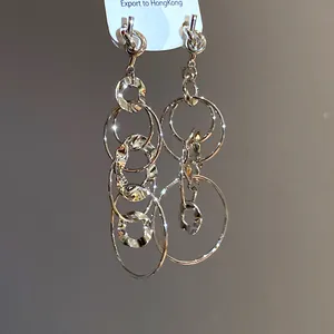 Elegant silver circular tassel earrings with knotted design and wrinkled texture details