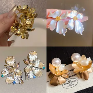 Elegant floral stud earrings set featuring gold, pearl and silver designs.