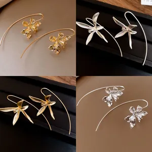 Elegant orchid flower drop earrings with long curved hooks in gold and silver finish.