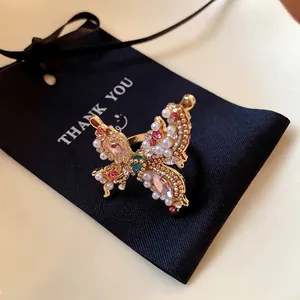 Elegant butterfly ring featuring pearls and colorful rhinestones in a French style.