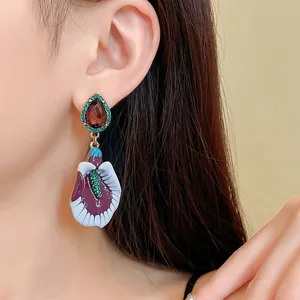 Close-up of vintage gradient violet enamel drop earrings with floral 3D relief details