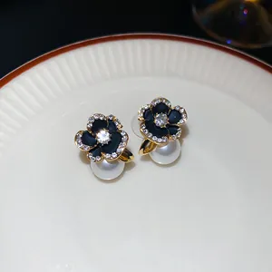 Detailed view of elegant black flower stud earrings with pearl drop and crystals