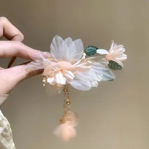 Elegant fabric flower hair clip with pearl tassels and leaves on a gold duckbill clip