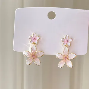 Elegant pink flower stud earrings with shimmering crushed stone petals and rhinestones