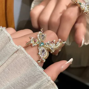 Detailed view of an elegant French-style butterfly ring with pearls and rhinestones.