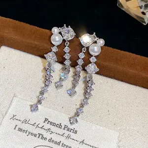 Elegant silver needle earrings with sparkling zircon and pearls in a long tassel design.