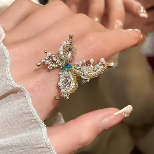 Exquisite close-up detail of a French style butterfly ring with rhinestones and pearls