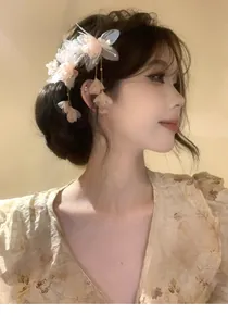 Asian model wearing a fairy-style fabric pink flower hair clip with dangling petal tassels