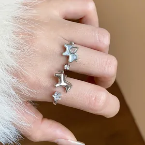 Detailed view of a silver adjustable ring featuring elegant pony charms and star-shaped zircons