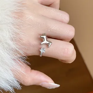 Close-up of adjustable silver star and pony ring with shimmering zircon detail