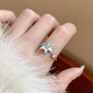 Detailed macro view of an adjustable silver pony ring featuring zircon and shell inlay
