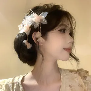 Detailed side view of an elegant fabric floral hair clip with gold tassels and pearls