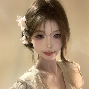 Close-up of an elegant fabric flower hair clip with pearl tassel worn by an Asian model