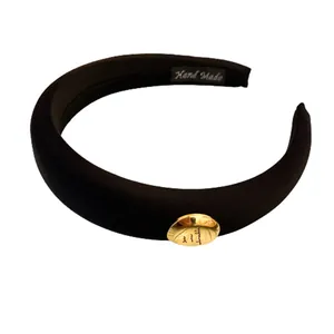 Stylish black padded sponge headband with gold oval metal ornament for women's hair