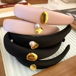 Close-up detail of padded sponge headbands with gold heart and pearl embellishments