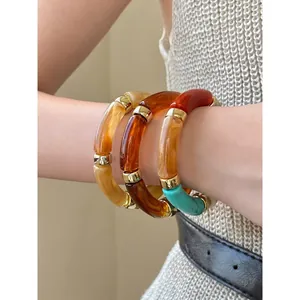 Retro acrylic marbled round bangle bracelet set with gold metal accents for women