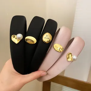 Close-up of padded sponge headbands with gold heart and pearl charms