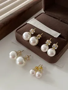 Detailed view of high luster round pearl stud earrings in various sizes with gold-tone studs