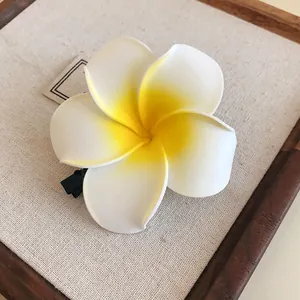 Tropical white and yellow plumeria flower hair clip for elegant beach style updos