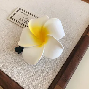 Realistic white and yellow plumeria flower hair clip for elegant hair styling