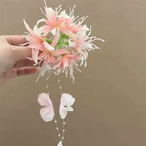 Elegant pink 3D artificial flower hair clip featuring long beaded butterfly tassels
