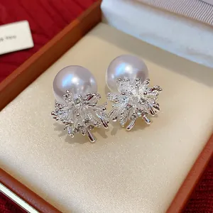 Detail view of silver fireworks pearl stud earrings in a luxury jewelry gift box
