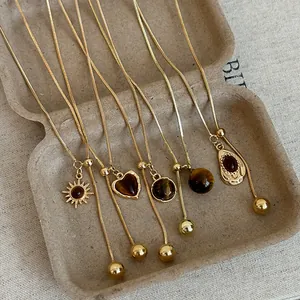 Gold-plated tiger eye adjustable lariat necklaces featuring sun and heart charms