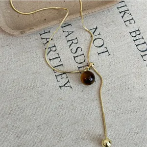 Elegant gold-plated Y-necklace with tiger eye stone bead and adjustable pull chain