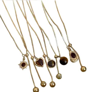 Elegant gold-plated tiger's eye necklaces with various pendants and adjustable pull chains