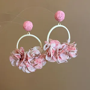 Detailed view of these sweet pink fabric flower hoop earrings perfect for vacation