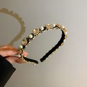 Detailed view of elegant Korean style headband featuring white pearls and sparkling rhinestones
