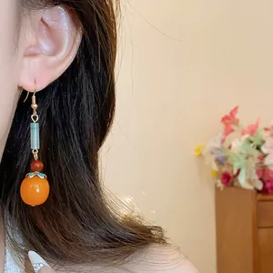 Detailed view of New Chinese style persimmon dangle earrings with resin beads.
