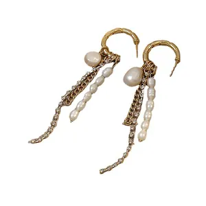Elegant C-shaped hoop earrings with pearl and rhinestone tassels on white background