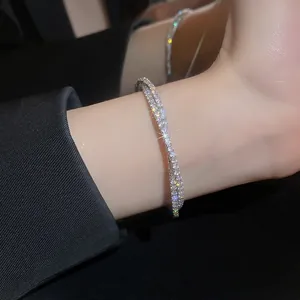 Elegant silver-toned double-row cubic zirconia bangle bracelet on a female wrist