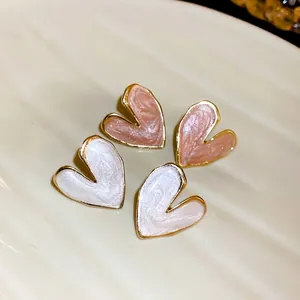 Elegant heart-shaped stud earrings with pink and white oil-drip enamel finish