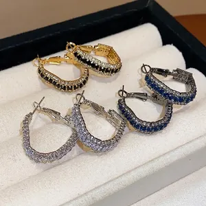 Elegant geometric zircon hoop earrings set in gold, silver and blue finishes for women.