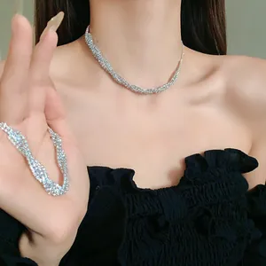 Elegant twisted rhinestone necklace and bracelet set worn by a female model