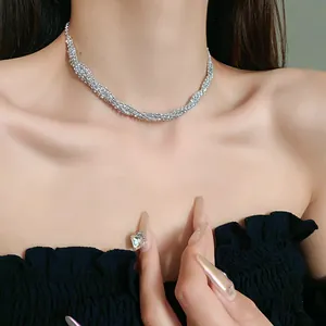Detailed close-up of a sparkling rhinestone choker necklace on a model wearing black.