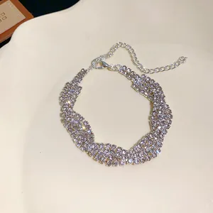 Close-up of a sparkling four-row rhinestone bracelet with an adjustable silver-tone chain