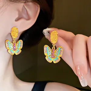 Vintage gold butterfly drop earrings with colorful rhinestones and elegant textured metal