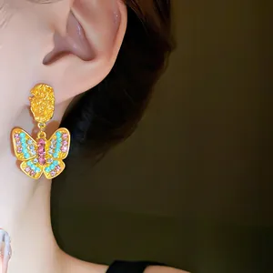Detailed close-up of a vintage-style butterfly earring with colorful rhinestones