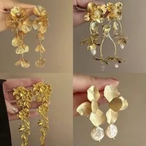 Detailed collage of four elegant gold floral tassel earrings with metallic textures.